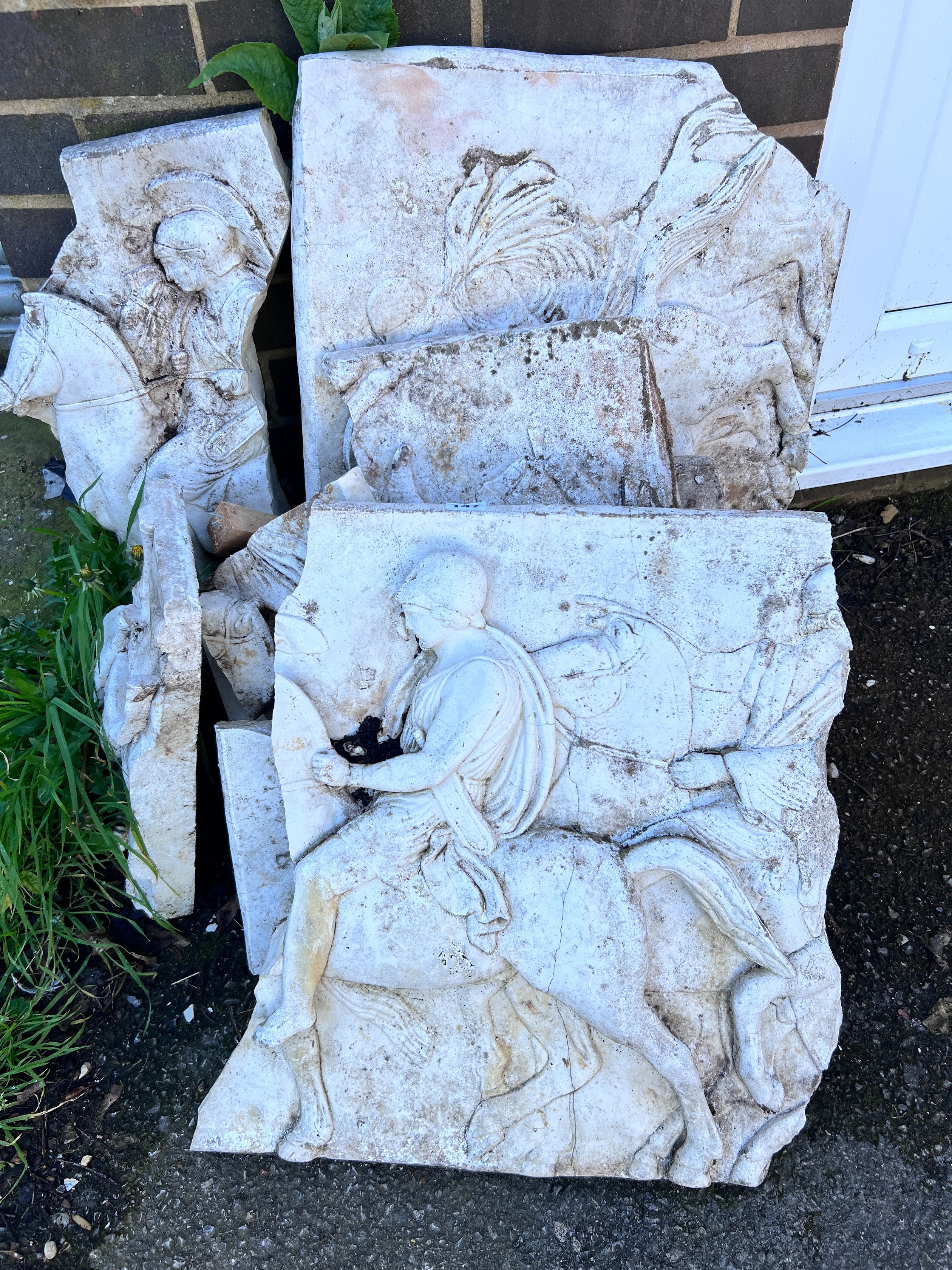 Nine reconstituted stone Parthenon style tablet fragments *Please note the sale commences at 9am.
